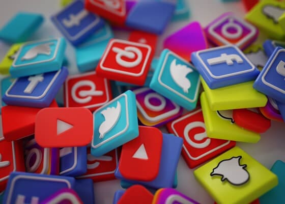 A pile of tokens with different social media logos on them