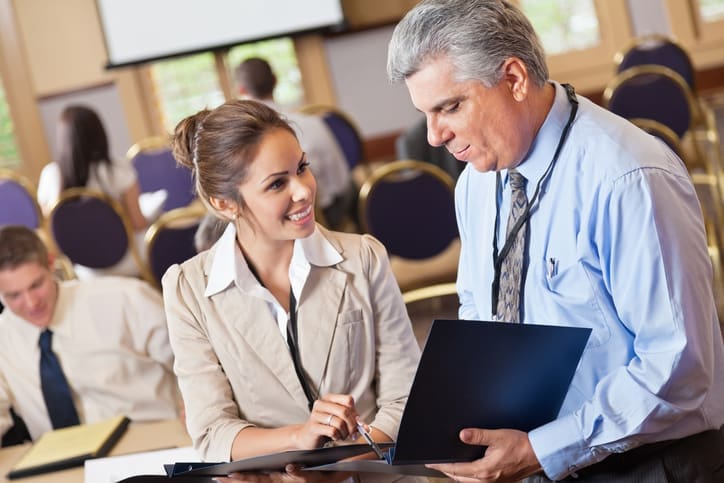 Two small business owners talking at a chamber of commerce meeting