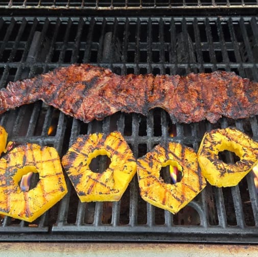 Meat and pineapple on a grill