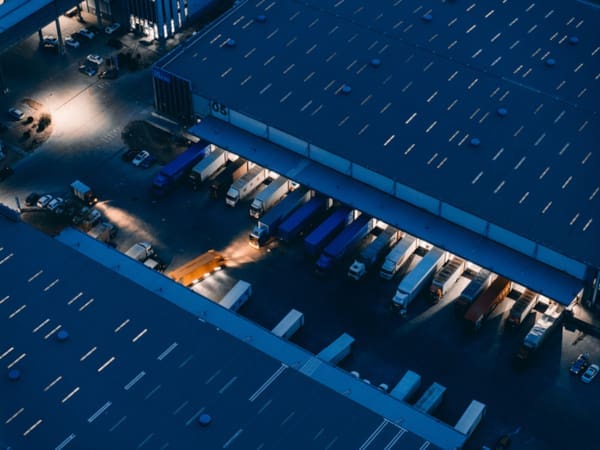 Semi trucks parked at a large logistics center