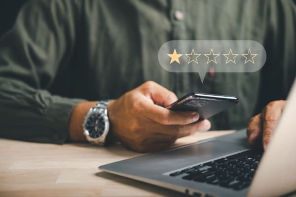 A business customer on a phone giving a 1 star review