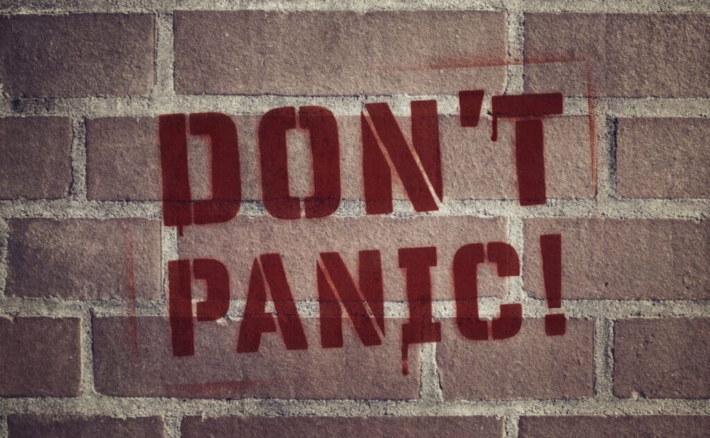 A wall spray painted with "Don't Panic"